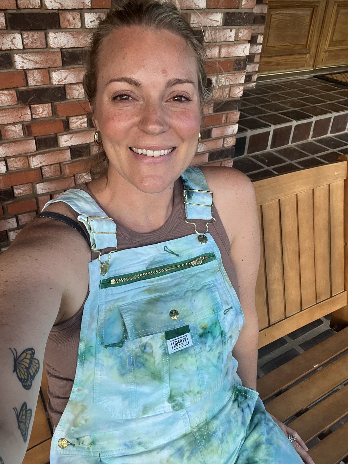 Lauren Eriksen in tie-dye LIBERTY overalls at her home