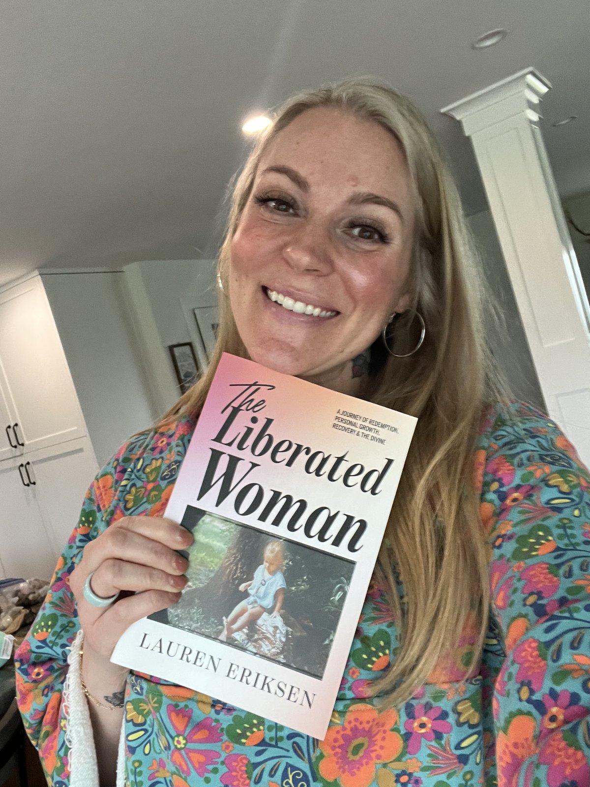 Lauren Eriksen holding her book The Liberated Woman